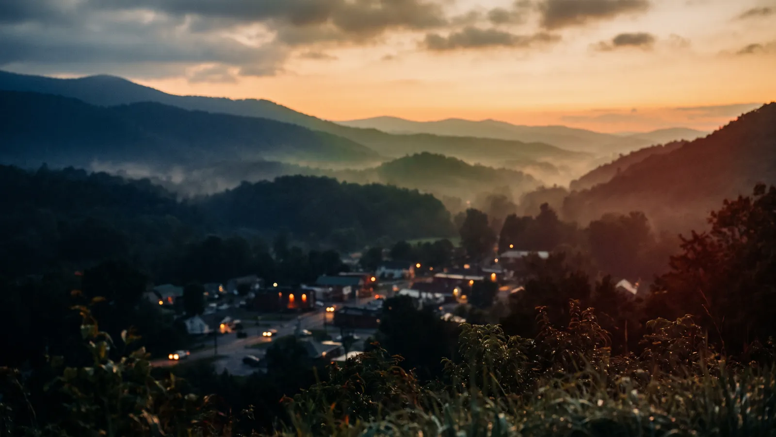 Blue Ridge ridgelines layered in haze above a small valley town.